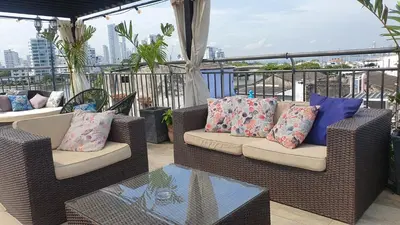 two wicker chairs and a table on a balcony at Casa Evelyn in Cartagena de Indias