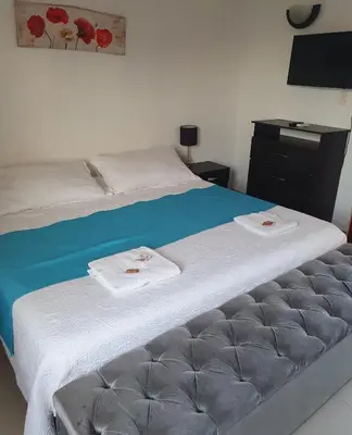 a bedroom with a bed with two towels on it at Casa Evelyn in Cartagena de Indias