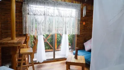 a room with a large window with white curtains at Hotel Calamari Baru in Playa Blanca