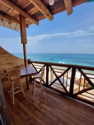 a balcony with a table and a view of the beach at Hotel Calamari Baru in Playa Blanca