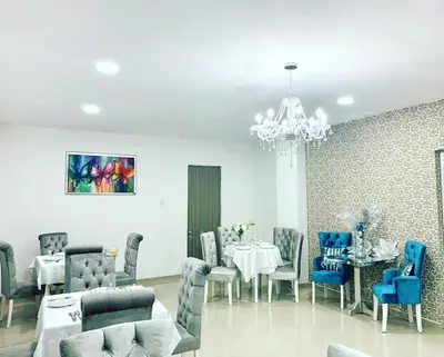 a dining room with a table and chairs and a chandelier at Hotel Platinum Barranquilla in Barranquilla
