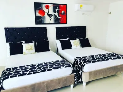 two beds sitting next to each other in a room at Hotel Platinum Barranquilla in Barranquilla
