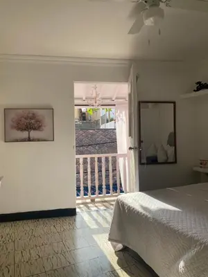 a bedroom with a bed and a door to a balcony at Balcones de Venecia in Cartagena de Indias