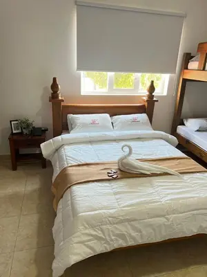 a bedroom with a bed with a swan on it at Hostal La Heroica in Cartagena de Indias