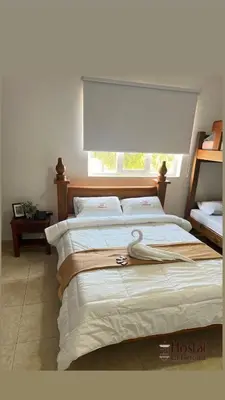 a bedroom with two beds and a window at Hostal La Heroica in Cartagena de Indias