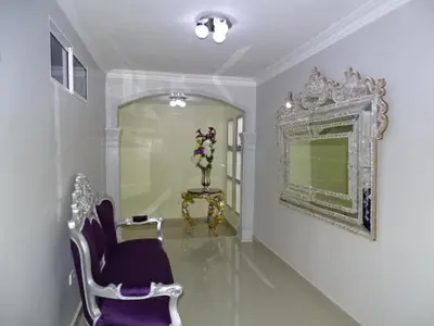 a room with chairs and a mirror and a table at Hotel Prado Real in Barranquilla