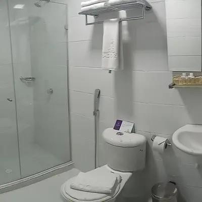 a bathroom with a shower and a toilet and a sink at Hotel Prado Real in Barranquilla