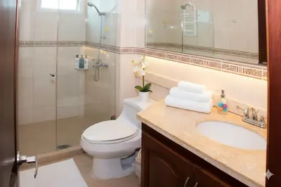a bathroom with a toilet and a sink and a shower at Torres del Lago B-2 in Cartagena de Indias