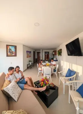 a family sitting on a couch in a living room at Torres del Lago B-2 in Cartagena de Indias