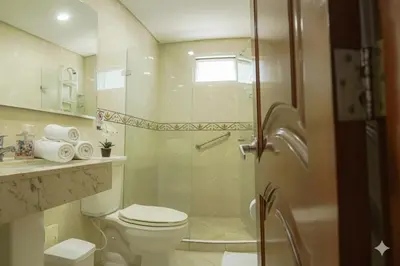 a bathroom with a toilet and a glass shower at Torres del Lago B-2 in Cartagena de Indias