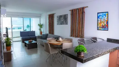 a living room with a couch and a table and chairs at Torres del Lago B-2 in Cartagena de Indias
