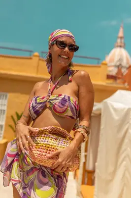 a woman in a bikini holding a basket at Casa Carolina Luxury Wellness Hotel in Cartagena de Indias