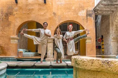 a group of three people standing next to a swimming pool at Casa Carolina Luxury Wellness Hotel in Cartagena de Indias