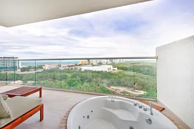 a large white tub in a room with a large window at Cielo Mar Regatta - LivinColombia in Cartagena de Indias