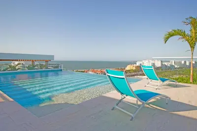 two chairs are sitting next to a swimming pool at Cielo Mar Regatta - LivinColombia in Cartagena de Indias