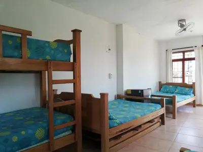 a room with three bunk beds in a room at Hotel Brisas del Mar San Antero in San Antero