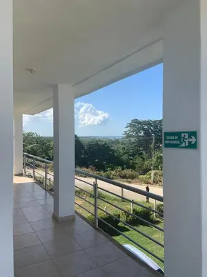 a building with a sign with a view of a field at Hotel Brisas del Mar San Antero in San Antero