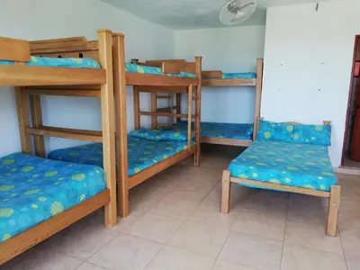a room with four bunk beds in a room at Hotel Brisas del Mar San Antero in San Antero