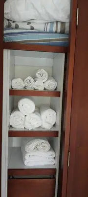 a closet filled with folded towels and a bed at Cartagena Boquilla Morros playa apt 1 in Cartagena de Indias