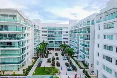 an aerial view of a building with palm trees and buildings at Cartagena Boquilla Morros playa apt 1 in Cartagena de Indias