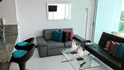 a living room with a couch and a glass table at APTO EN LA BOQUILLA CARTAGENA MORROS 922 in Cartagena de Indias