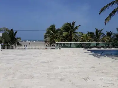 a volleyball court on a beach with palm trees at APTO EN LA BOQUILLA CARTAGENA MORROS 922 in Cartagena de Indias