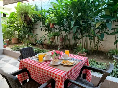 a table with a red and white checkered table cloth at Hotel Boutique M in Barranquilla