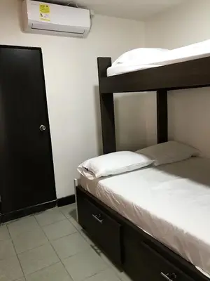 a bedroom with a bunk bed and a closet at La Quinta Bacana in Barranquilla