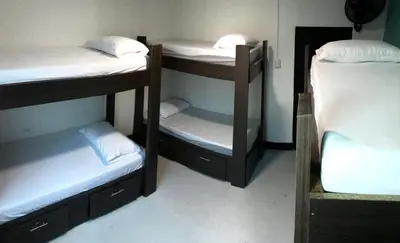 a room with three bunk beds in a room at La Quinta Bacana in Barranquilla