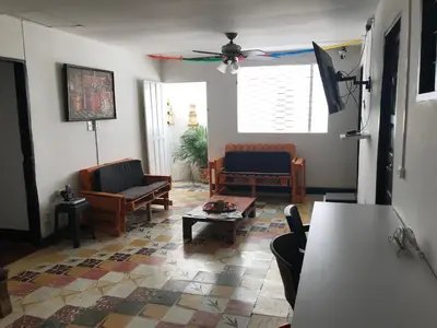 a living room with chairs and a ceiling fan at La Quinta Bacana in Barranquilla