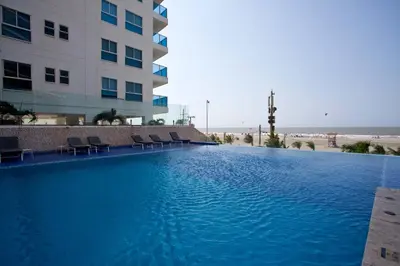 a large swimming pool in front of a building at Bello apartamento dentro del Hotel Radisson Ocean Pavillion in Cartagena de Indias