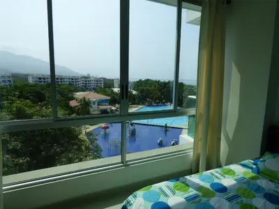 a room with a window with a view of a swimming pool at Costa Azul Suites 403 in Santa Marta
