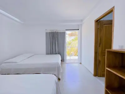 a bedroom with two beds and a window at Condominio bahia blanca in Coveñas