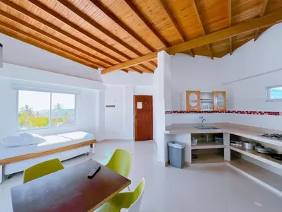a kitchen and dining room with a table and chairs at Condominio bahia blanca in Coveñas