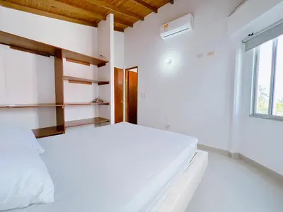 a bedroom with a bed and a window at Condominio bahia blanca in Coveñas