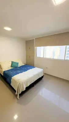 a bedroom with a large bed in a room at Hermoso Apartamento en Bocagrande-Cartagena in Cartagena de Indias