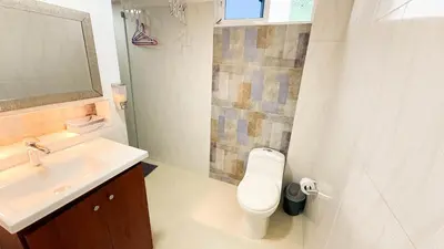 a bathroom with a white toilet and a sink at Hermoso Apartamento en Bocagrande-Cartagena in Cartagena de Indias