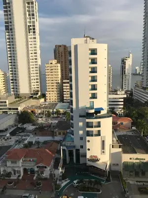 a tall white building in a city with tall buildings at Hermoso Apartamento en Bocagrande-Cartagena in Cartagena de Indias