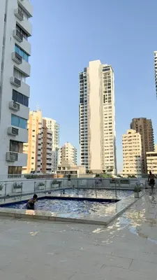 a person in a pool in a city with tall buildings at Hermoso Apartamento en Bocagrande-Cartagena in Cartagena de Indias