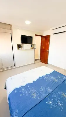 a bedroom with a bed with a blue blanket at Hermoso Apartamento en Bocagrande-Cartagena in Cartagena de Indias
