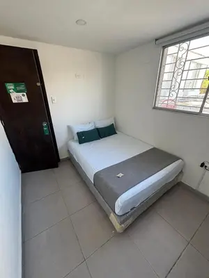 a small bedroom with a bed in a room at Casa Prado 59 in Barranquilla