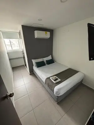 a bedroom with a bed and a television in it at Casa Prado 59 in Barranquilla