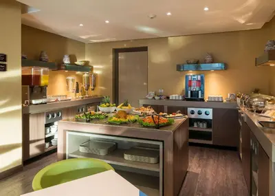 a kitchen with a counter with food on it at Hampton by Hilton Barranquilla in Barranquilla