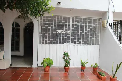 a white garage door with plants on it at Aqui me quedo in Cartagena de Indias