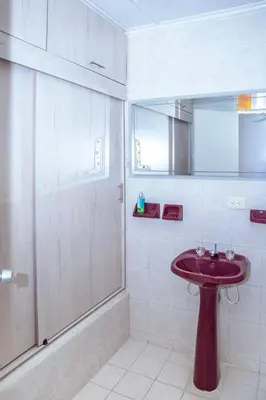 a bathroom with a red sink and a shower at Aqui me quedo in Cartagena de Indias