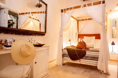 a bedroom with a canopy bed with a mirror at Leones de Alba Hotel Boutique in Cartagena de Indias