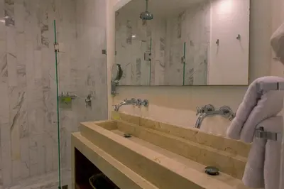 a bathroom with a sink and a shower with a mirror at Leones de Alba Hotel Boutique in Cartagena de Indias