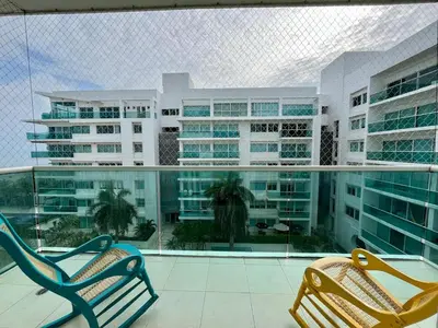 two chairs on a balcony in front of a building at Apartamento en cartagena Boquilla vista al mar dos Hab in Cartagena de Indias