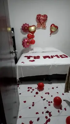 a bedroom with a bed with red flowers on the floor at LA MEDELLIN HOSTAL in Cartagena de Indias