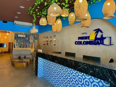 a hotel lobby with a new colombian sign and lights at Hotel Puerto Colombia in Puerto Colombia